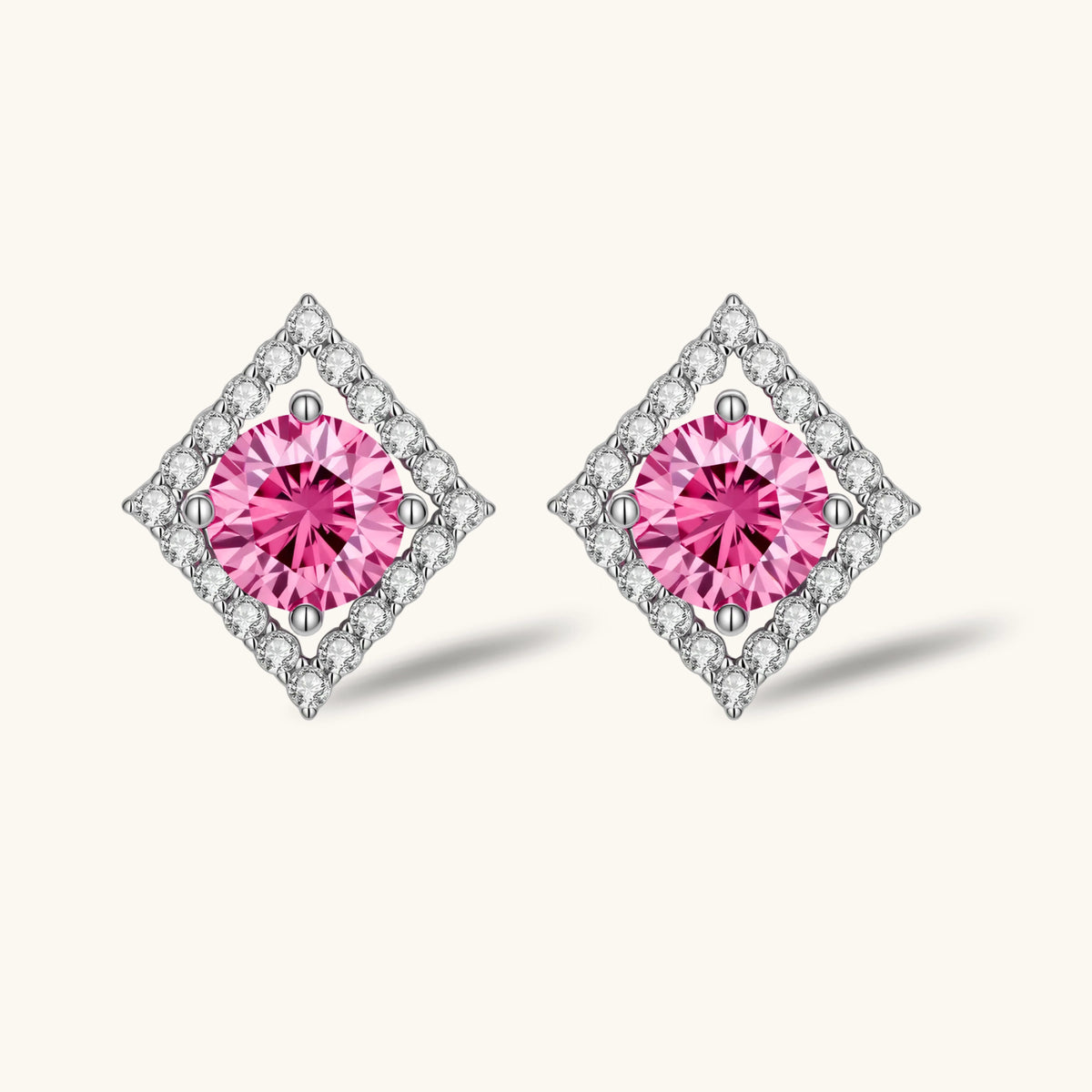 Sterling silver diamond-shaped stud earrings with pink moissanite center stones and crystal halo setting on white background