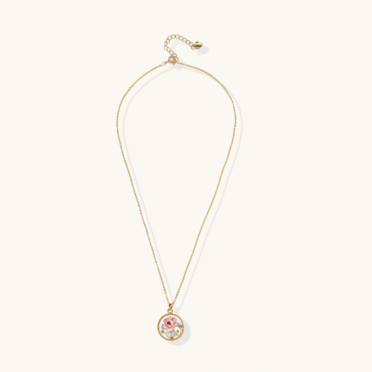 Gold-plated circular pendant with pink enamel rose, pearl background, and delicate beaded border on chain