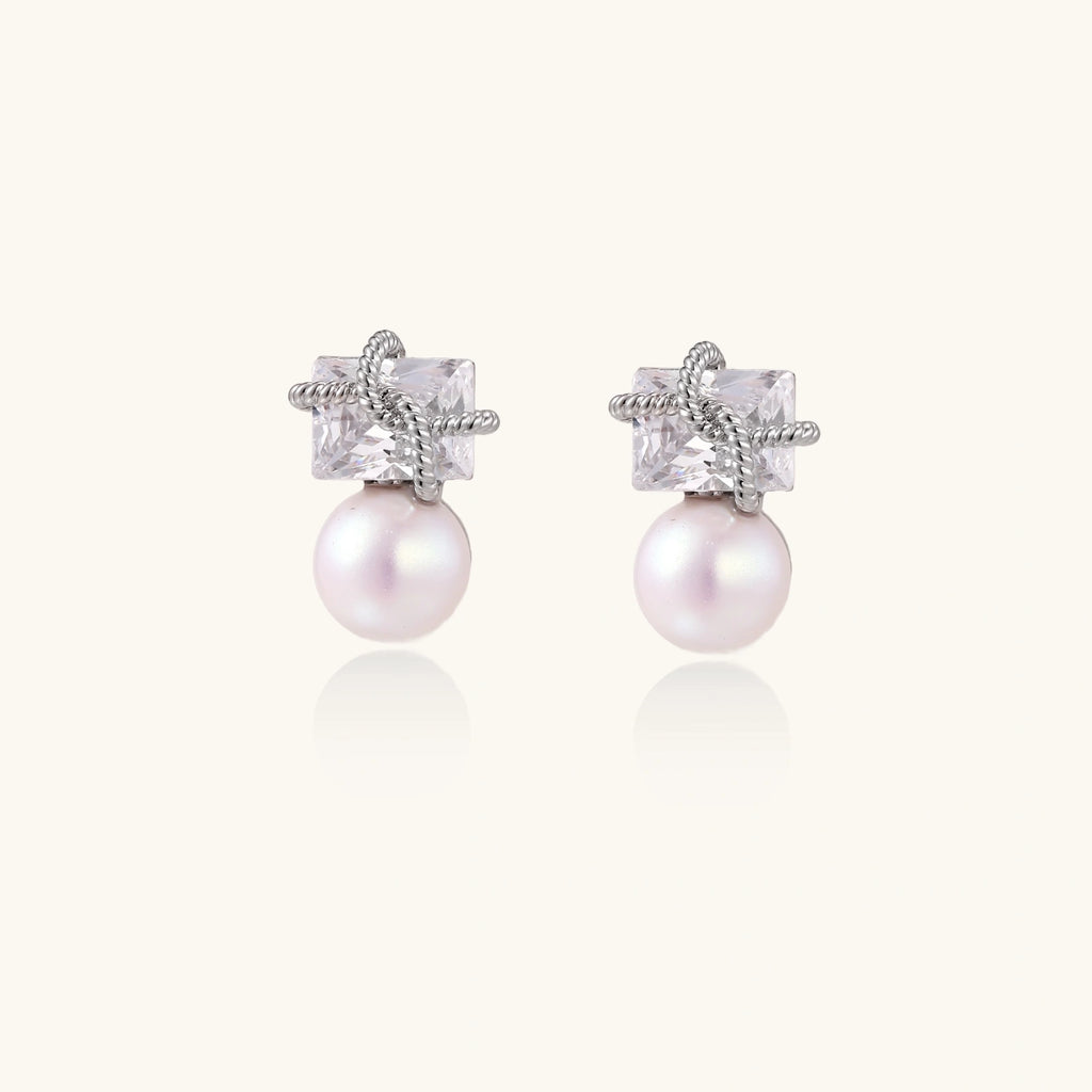 White gold stud earrings with square crystal stones in twisted frames and pink freshwater pearl drops below